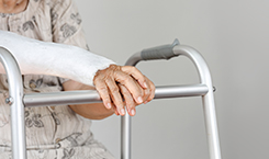 elderly patient with broken arm waiting on her walker